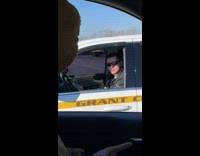 Guy and police officer vibing to song in parking lot