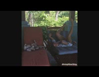 Woman copies her dog's sleeping position in a chair