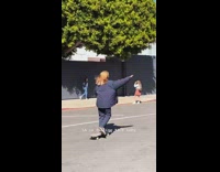 Girl denim jacket wall under tree skateboard