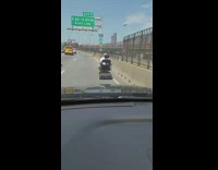 Guy drives mobility scooter on freeway 