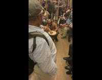 Shirtless man red sunglasses plays bongo drums in aisle of subway train