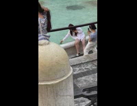 Woman swipe credit card on fountain pool