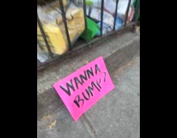 Person films crowd and signage at marathon
