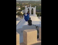 Woman in blue dress poses on the church roof Part 2