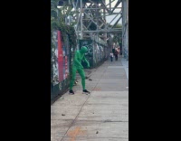 Collab WINY - Person wearing green screen suit taking pictures of shoes 
