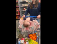 Toddler on shopping cart head hang down
