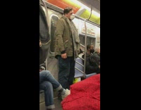 Guy riding subway while lifting a dumbbell