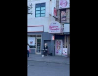 Person wears bear head costume plays music