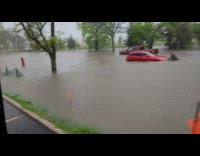 Collab WINY - Man with red car stranded on flooded road