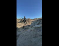 Guy rides bike over cliff