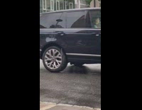 Orange jumpsuit girl poses with trash can 