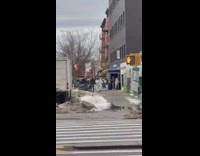 People in jumpsuits passing down trash bags in line