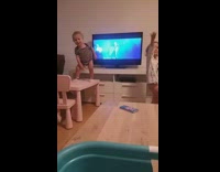 Infant and toddler siblings dance to Taki Taki at home with music video on TV