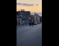 Grey cropped sweater girl dances empty street
