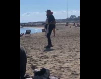 Guy on beach dances to music