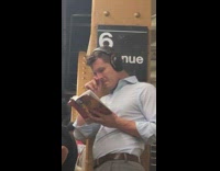 Guy headphones on picks nose and eats boogers while reading book in subway station 6 avenue