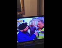 Guy takes photo of news interview live broadcast 