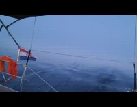 Person on boat sail towards sunrise fog