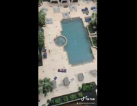 Guy throws water balloon 11 stories