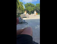 Woman in a beach hat kneels on the sun lounger
