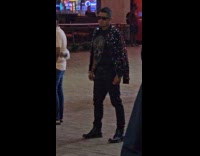 Collab IITW - Man shiny coat poses at amusement park