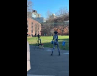 Woman wears spiderman costume films at park