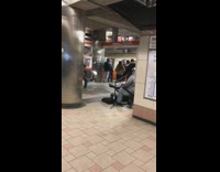Guy plays keyboard at train station 
