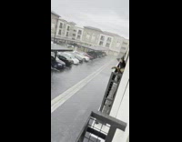 Guy film rain see neighbors dog on balcony