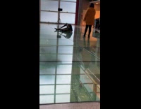 Collab IITW - Woman in blue top and skirt lie rolls on the glass floor