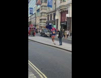 Blue jersey shirt girl dances road divider 