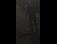 guy trying to ride skateboard falls down 