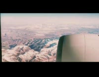 Girl pretends to look out airplane window 