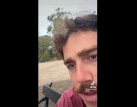 Man Claims Dominance on Bench at Park