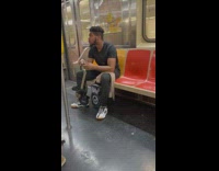 Guy riding subway combs beard and blasts music 