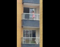 Girl pink skirt knee up pose balcony