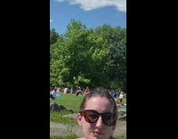 Girl white sleeveless dress stand crowded park