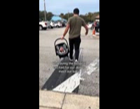 Couple introducing newborn to dog 