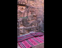 Girl sets rug on edge of cliff 