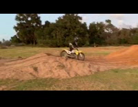 Dirt biker jumps high over dirt ramp and crashes hard on landing