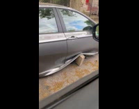 Smashed car stolen tires parked at street