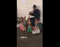 man playing flute dancing dolls around him