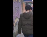 Man walks with kitten on his hoodie