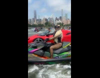 Woman wears leopard costume rides jet ski