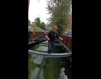 Guy runs jumps across metal bars water
