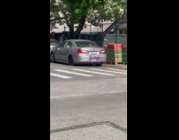 Word Bitch spray painted on gray car