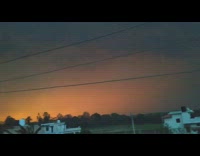 Thunder lightning storm white houses orange sky