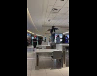 Men Sit and Dance on Food Court Tables for Video