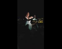 Woman white romper night time phone light