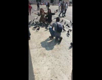 Two ladies squat pose with pigeon birds 