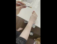 Newly neutered orange cat gets fed through syringe